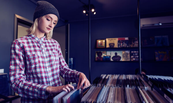 beautiful young woman browsing records in the vinyl record store beautiful young woman browsing records in the vinyl record store