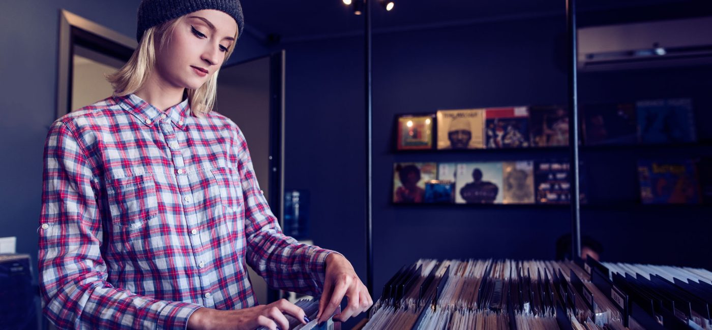beautiful young woman browsing records in the vinyl record store